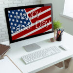 Marketing expert planning a Labor Day email campaign on laptop
