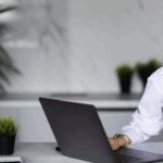 A woman writing an email on a laptop, focusing on email marketing strategy